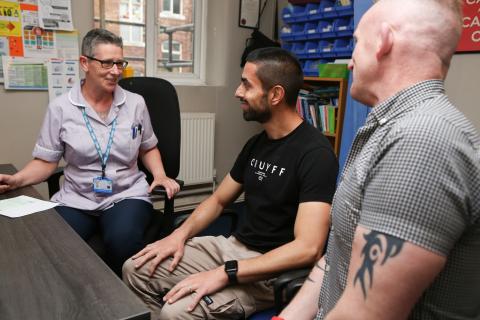 Two men visiting a nurse for a consultation